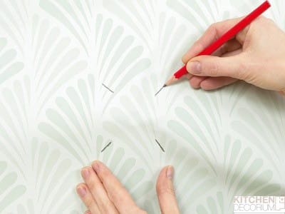 How to glue wallpaper near outlets and switches