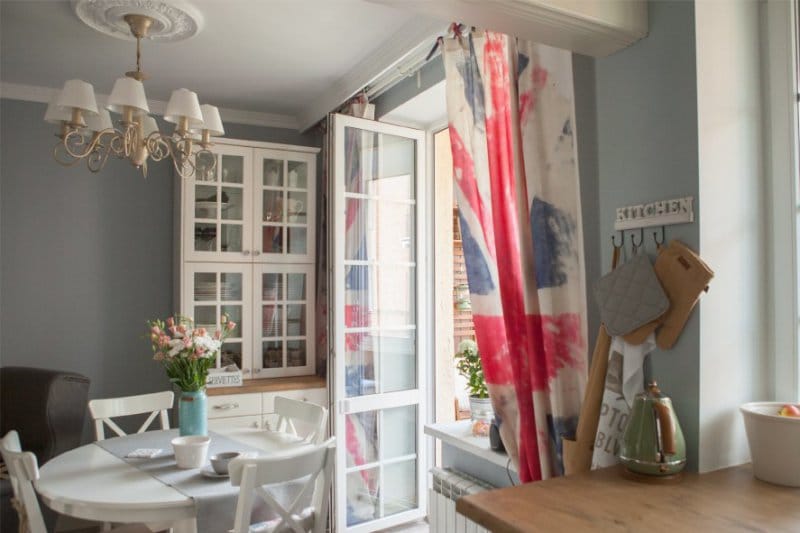 The interior of the kitchen in the English style and curtains in the form of the British flag